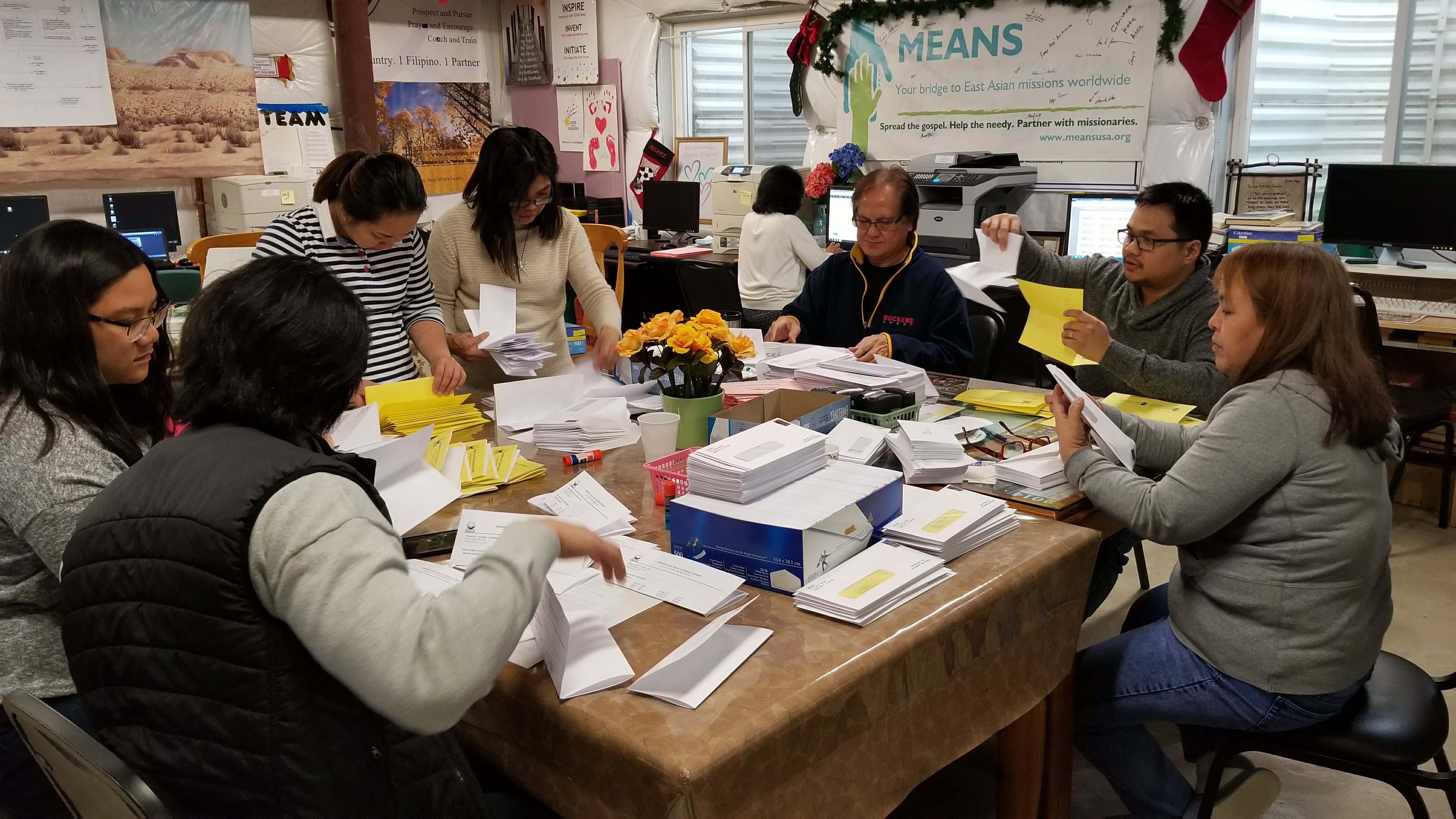 Volunteers stuffing mailings